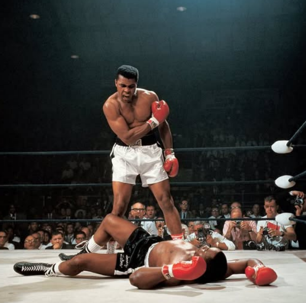 Muhammad Ali standing in the ring after a knockout
